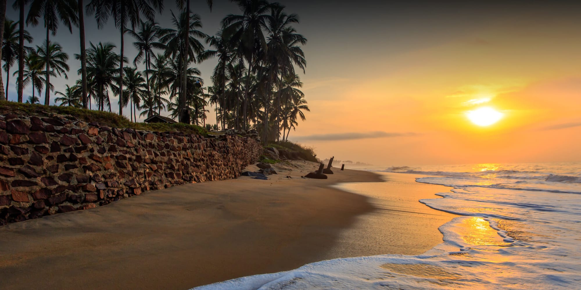 Peaceful shoreline with soft waves at sunset